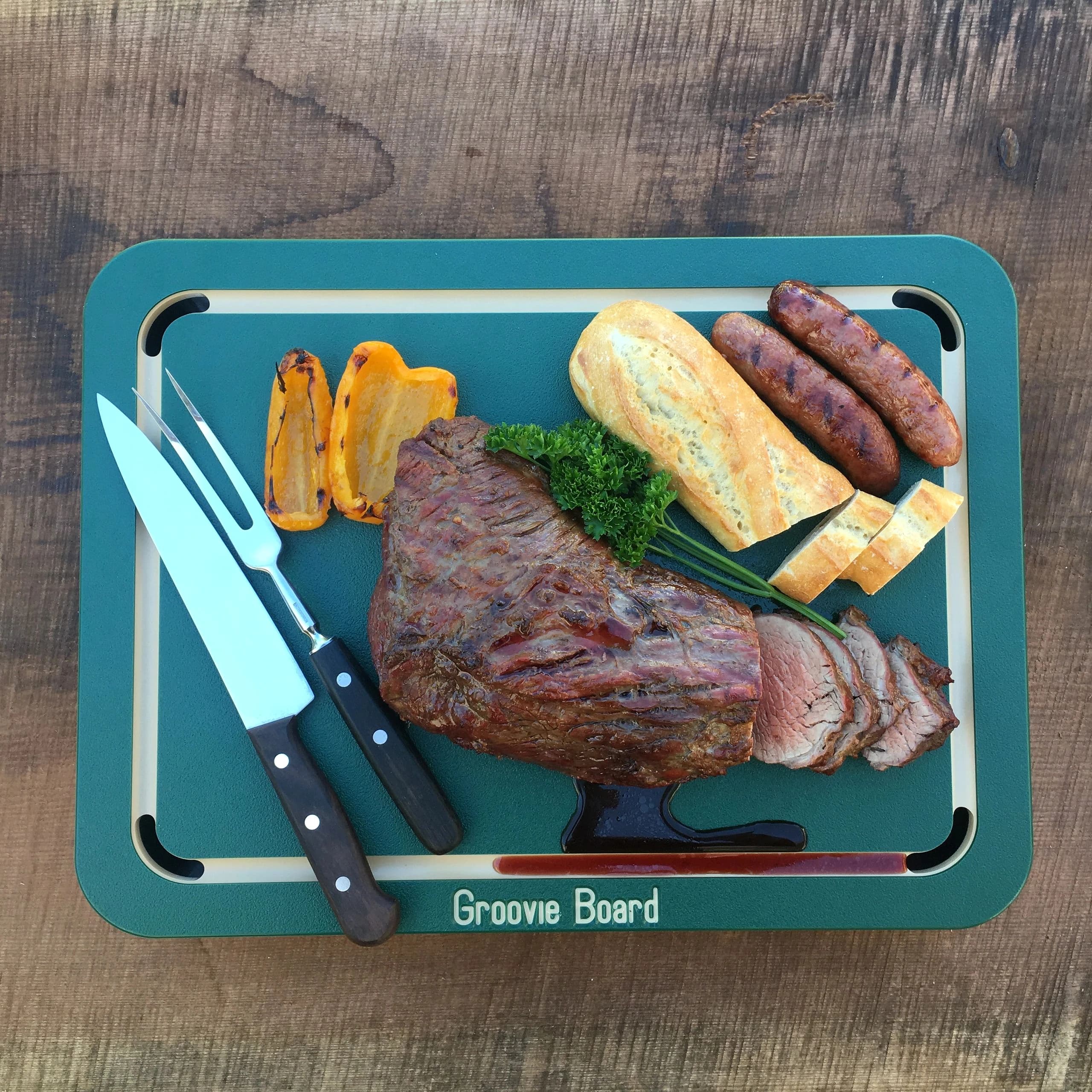 Groovie Board serving roast, bread, and grilled vegetables
